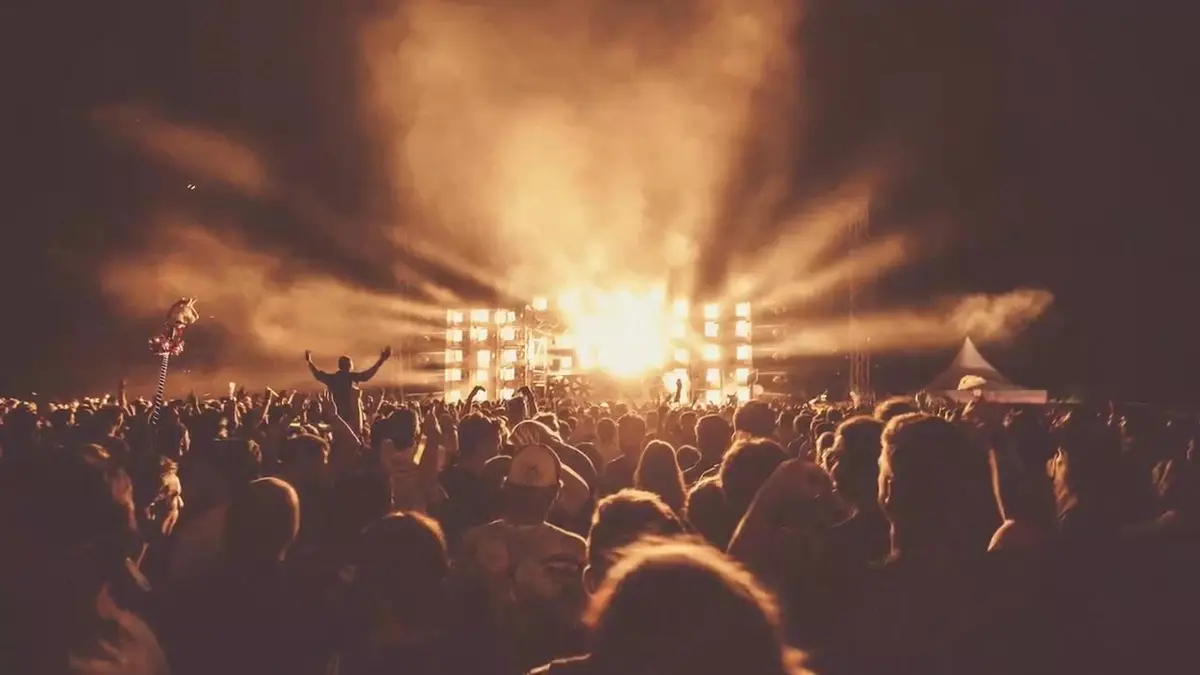 Crowd under stage lights at a launch party